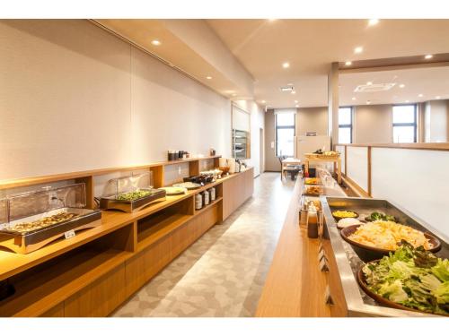 a kitchen with many trays of food on display at Second Inn Hana Hotel Hanazono Inter - Vacation STAY 40299v in Fukaya