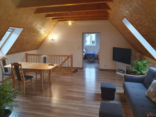 a living room with a table and a tv at Dom Porost in Porost