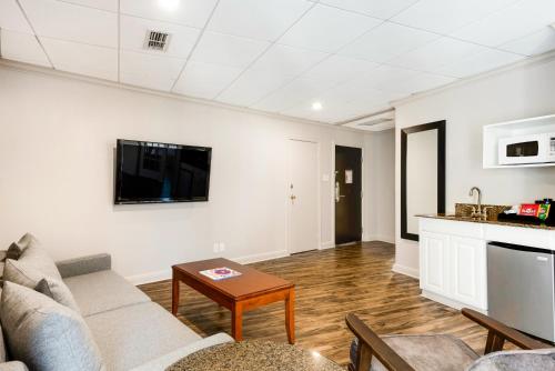 a living room with a couch and a table at Riverwalk Plaza Hotel in San Antonio