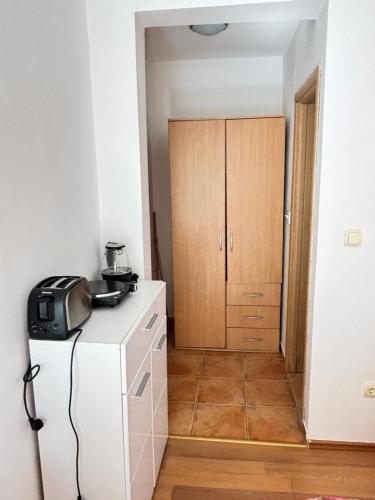 a kitchen with a white refrigerator and a cabinet at Montetolgay in Becici