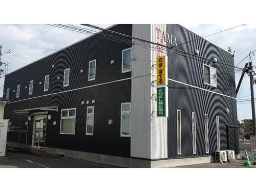 a black building with a sign in front of it at TAMA HOTEL - Vacation STAY 41338v in Ishinomaki