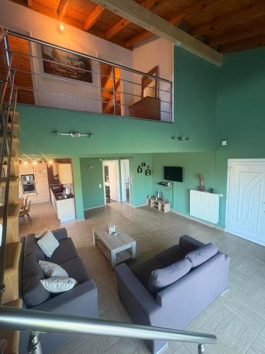 a living room with a couch and a balcony at Alex house in Kouramaditika