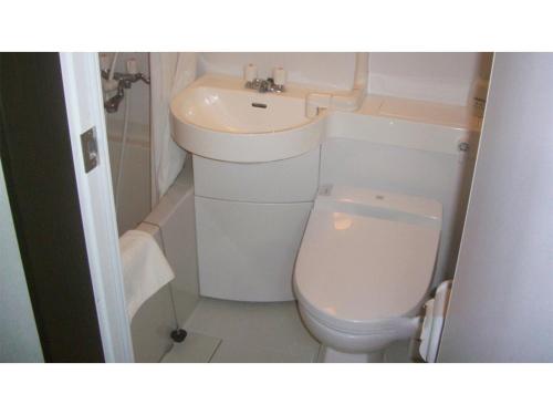 a small bathroom with a toilet and a sink at TAMA HOTEL - Vacation STAY 41312v in Ishinomaki