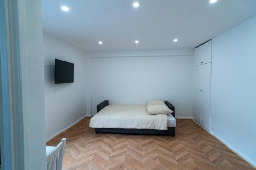 - une petite chambre avec un lit et une télévision dans l'établissement Little Sacré-Coeur Nest !, à Paris