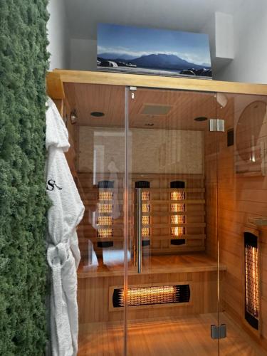 a bathroom with a glass shower with a tv on top at Scugnizzo Apartment in Naples