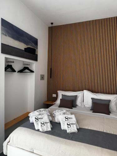 a bedroom with a large bed with towels on it at Scugnizzo Apartment in Naples