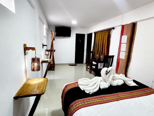 a bedroom with a bed with a towel on it at Hotel Sal Andina in Uyuni