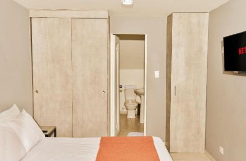 Ένα ή περισσότερα κρεβάτια σε δωμάτιο στο Apartamentos y Loft Laureles