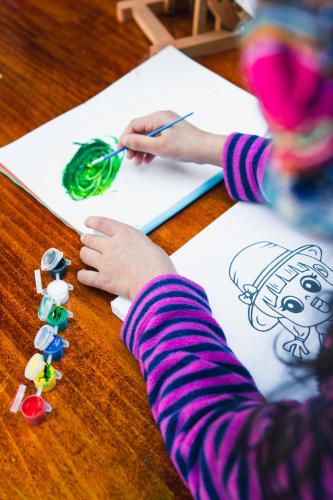 a child drawing a picture on a paper on a table at Casa Andina Premium Cusco in Cusco