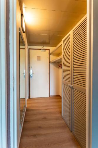 a hallway of an empty room with wood floors at Hotel Fleur d'Epee in Le Gosier