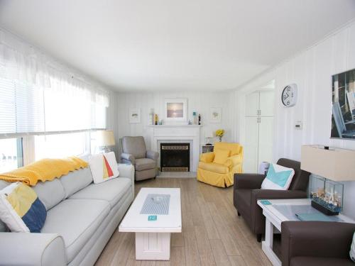 a living room with a couch and a fireplace at Peters 2680 in Beach Haven Crest