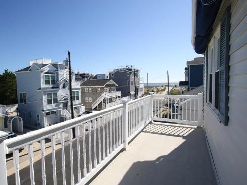 a balcony with a white railing on a house at Peters 2680 in Beach Haven Crest