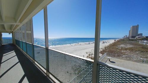 a balcony with a view of a beach and the ocean at COUPLES GETAWAY, HONEYMOON SWEET, Perfectly Cozy Beach Front Condo with kitchen, pool, free parking,CHECK-IN AT DOOR in Panama City Beach