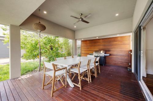 a dining room with a white table and chairs at Maori in Rye walk to the beach and shops in minutes in Rye