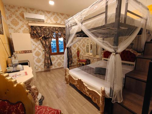 a bedroom with a bed with a canopy at Jessica Flat Malta Royal Guesthouse in Cospicua