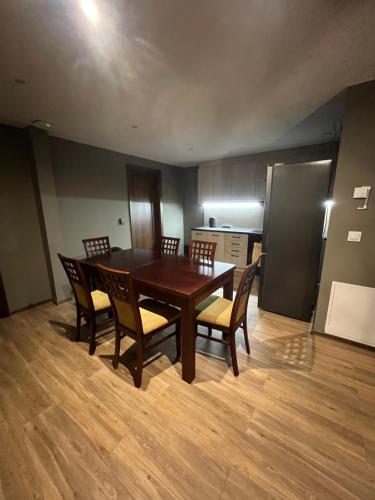 a dining room with a wooden table and chairs at Bestdrive Pokój 14 in Babienica