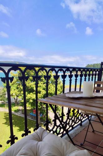 a balcony with a table and a view of a park at The Cliffs - Guiana Mar in O Vicedo