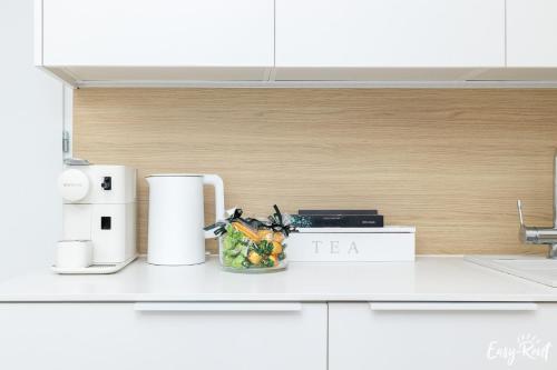 a kitchen counter with a bowl of fruit on it at Prestige Pinea z basenem - Easy - Rent Apartments in Pobierowo