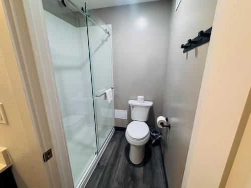 a bathroom with a toilet and a glass shower at Studio 6 Southgate MI Detroit in Southgate