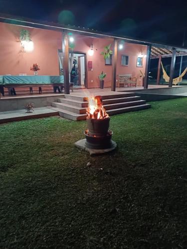 a fire pit in front of a house at night at Pousada da Elizângela de Amarantina in Ouro Preto
