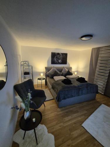 a bedroom with a bed and a couch and a chair at Ruheoase mitten in der Stadt in Pirmasens