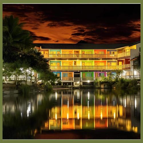 a building next to a river at night at Amoras Hotel fazenda in Santo Antônio de Jesus
