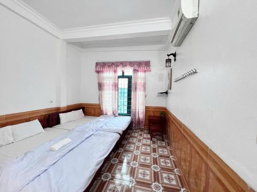 a room with two beds and a window at Ninh Binh Cozy Homestay in Ninh Binh