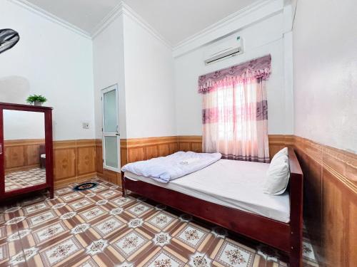 a small bedroom with a bed and a window at Ninh Binh Cozy Homestay in Ninh Binh