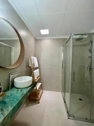 a bathroom with a sink and a glass shower at H Bellavista Mojácar in Mojácar