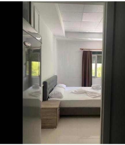 a bedroom with a bed and a window at Ama Apartment Tirana in Tirana