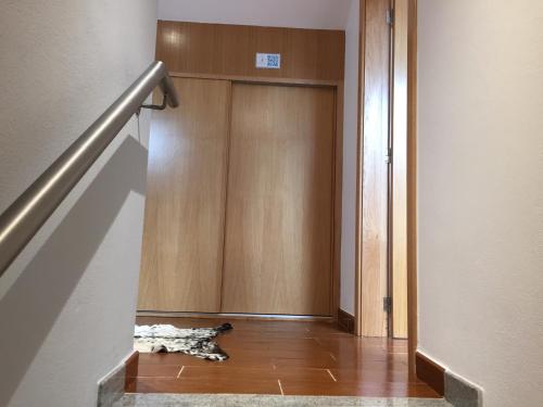 a dog laying on the floor in front of a door at Gites Des Sablons in Châtillon-sur-Marne