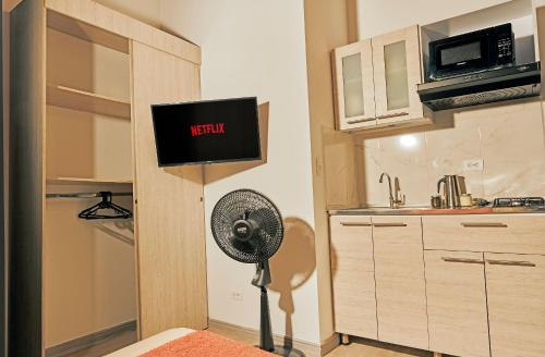 a kitchen with a fan in the corner of a room at Apartahotel Poblado-Aguacatala in Envigado