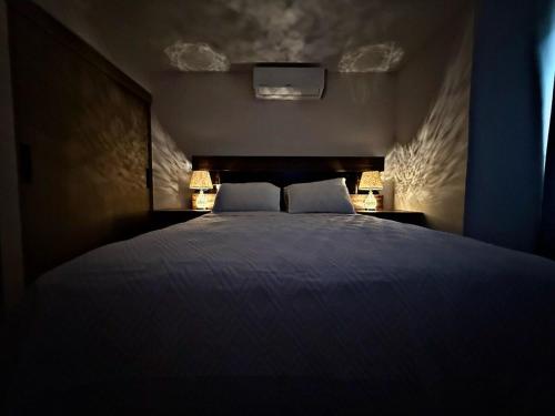 a bedroom with a large bed with two pillows at New and Luxurious Apt in Cipreses de San Ignacio in Tegucigalpa