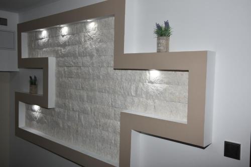 a brick wall with lights on it at Apartments Lavendula in Vodice