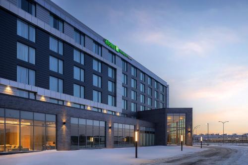 a rendering of a hotel in the snow at Holiday Inn Express Montreal Airport - St-Laurent by IHG in Montréal