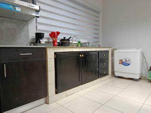 a kitchen with a sink and a refrigerator at Apartamentos Marconela in San Mateo