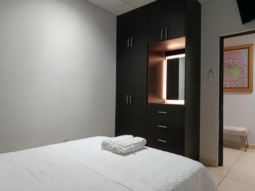 a bedroom with a bed with two towels on it at Apartamentos Marconela in San Mateo