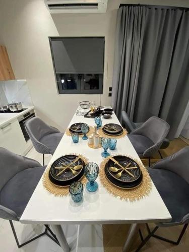 a table with plates and bowls on top of it at Luxury Villas Chrysa Private Pool & Spa in Nafplio