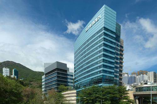 a tall building with a sign on the side of it at Le Méridien Hong Kong, Cyberport in Hong Kong