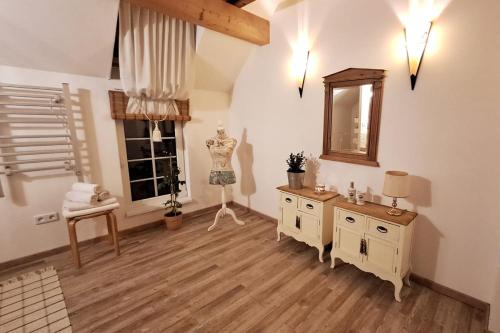 a room with a dresser and a mirror on the wall at Mountains Galerie Apartment Hana in Chvalov