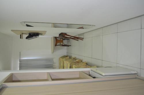 a kitchen with white walls and a counter with dishes at Annamar Hotel in João Pessoa