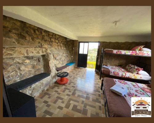 Postel nebo postele na pokoji v ubytování Hospedaje Villa de piedra