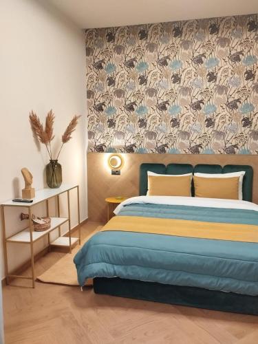 a bedroom with a bed with a blue and yellow blanket at Luxury Villas Chrysa Private Pool & Spa in Nafplio
