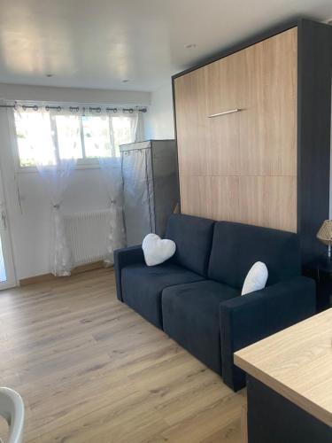 un salon avec un canapé bleu avec deux coussins blancs dans l'établissement Studio cosy Cannes à 250 m de la plage, pointe Croisette, à Cannes