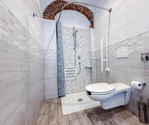a white bathroom with a toilet and a shower at Villa Mimosa in Cassano Magnago