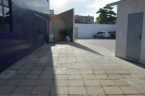 a shadow on a sidewalk next to a building at Annamar Hotel in João Pessoa