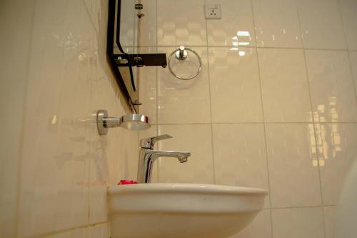 a bathroom with a sink and a shower at Good News Hotel in Kigali