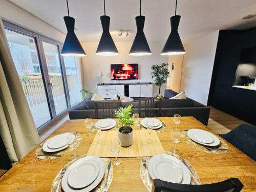 a living room with a wooden table with chairs and a couch at Stunning 2 bedrooms with private terrace in Luxembourg in Luxembourg