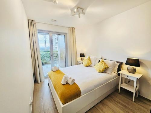 a bedroom with a large bed with a window at Stunning 2 bedrooms with private terrace in Luxembourg in Luxembourg