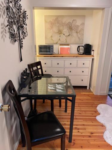 a glass table and chairs in a room at Arcata Forest Retreat Peaceful Redwood Suite 5 min to Downtown Arcata w Private Patio Fountain & Fire Pit in Arcata